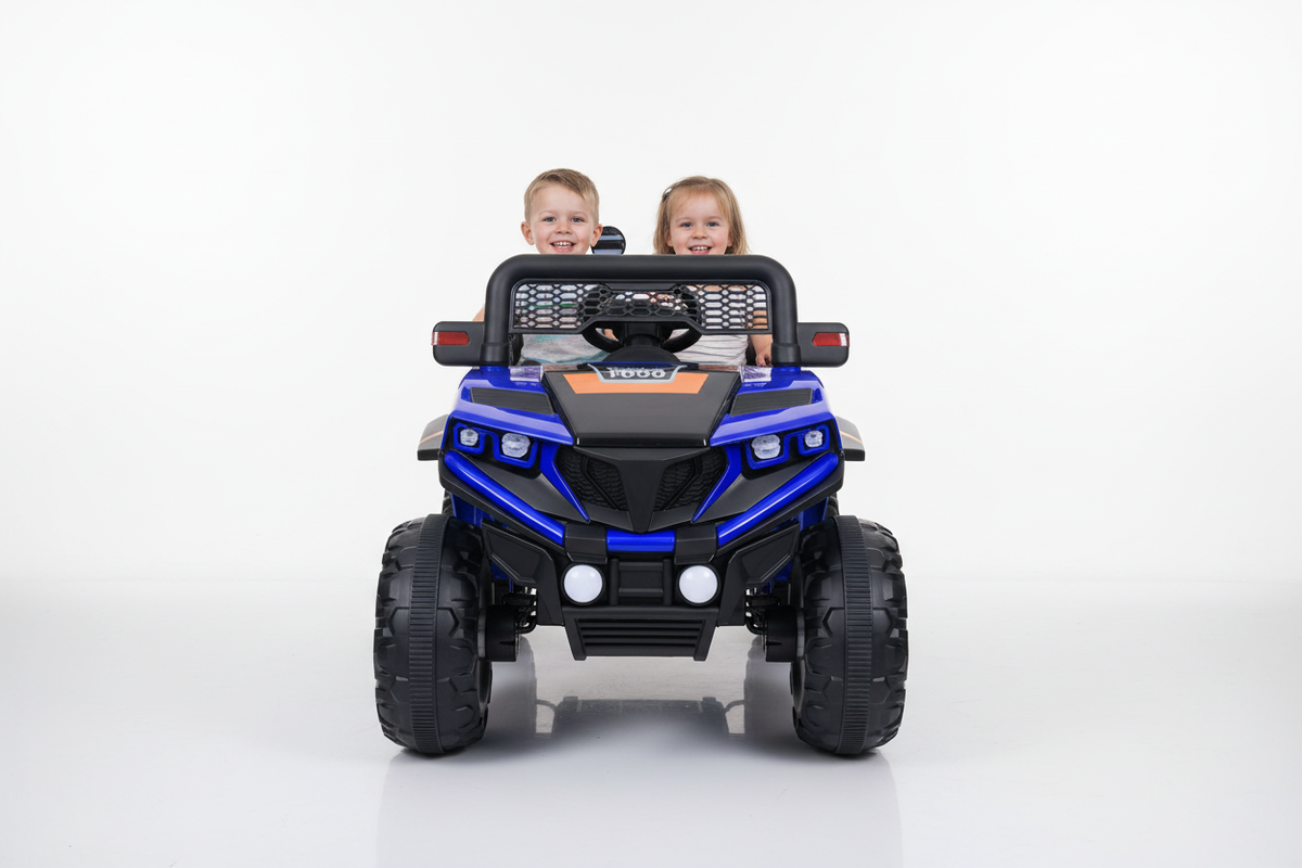 Large exact blue kids 12V electric ride-on Jeep with children in a white studio